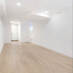finished basement after flood restoration in Toronto with new flooring and clean walls