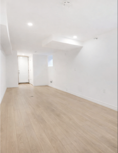 finished basement after flood restoration in Toronto with new flooring and clean walls